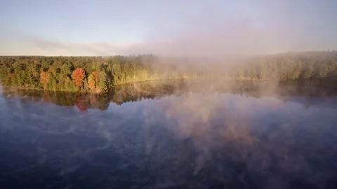 Drone captures daybreak mist elevating above the waterline. Stock Footage 321392739