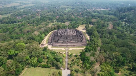 Drone Captures Iconic Borobudur Temple Amidst Lush Java Scenery Video stock 317547404