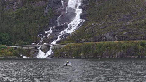 Drone captures Langfossen waterfall with boat below in scenic Norway Stock Footage 320245064