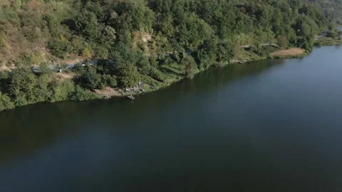 Drone captures men camping and fishing on a large river of Danube in Serbia Stock Footage 263133406