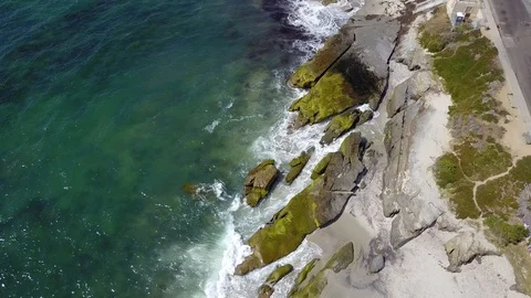 Drone captures ocean waves crashing on rocks on a sunny San Diego summer day Stock Footage 97972867