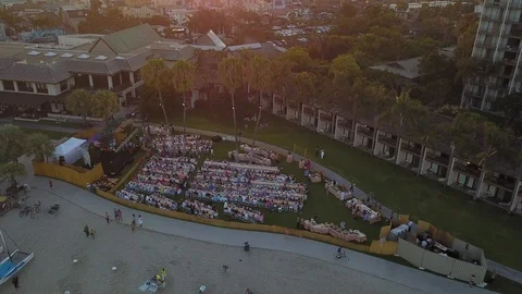 Drone captures outdoor event at beach resort then ascends to 350' at sunset Stock Footage 97199842
