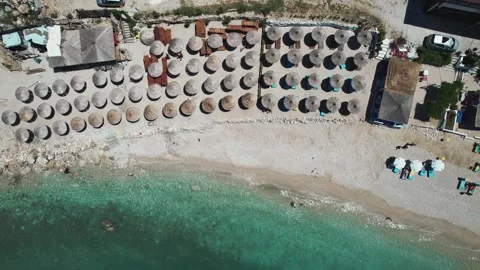 Drone captures a picturesque beach in Vlor, Albania, with rows of umbrellas a Stock-Footage 330696904