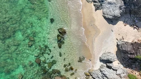 A drone captures the pristine beauty of a secluded beach. Video stock 307775180