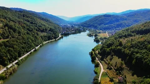 Drone captures a river Danube in valley of green wooded hills in sunny day Stock Footage 263139827