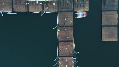 Drone Captures Rowing Boat Teams Finishing Practice At Dock In Ocean Bay Stock Footage 317997457