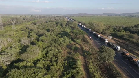 A drone captures a scene of a large number of cargo trucks stuck in a long Stock Footage 278449011