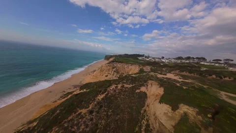Drone captures scenic coastline with beach, cliffs, and ocean waves Stock Footage 340225181