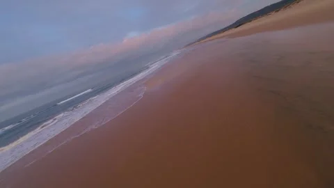 Drone captures serene beach with rolling sand dunes Video stock 344543436