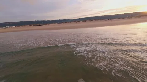 Drone captures serene sunrise beach scene Stock Footage 344543779