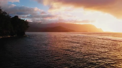 Drone captures the shadows of the mountains at sunset and cliff with a palm tree Stock-Footage 136428049