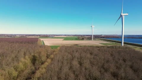 A drone captures a stunning aerial view of wind turbines in a rural landscape Stock Footage 305247458