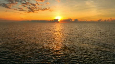 The drone captures a stunning tropical sunset over the ocean. Stock Footage 308054701