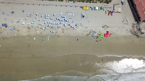 Drone captures sunbathers on a La Jolla beach on a sunny San Diego summer day Stock Footage 97972232