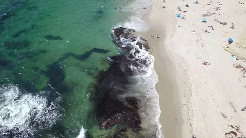 Drone captures sunbathers on a La Jolla beach on a sunny San Diego summer day Stock Footage 97972440