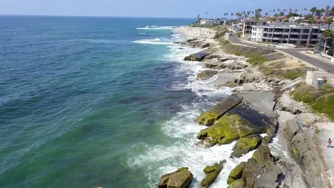 Drone captures sunbathers on a La Jolla beach on a sunny San Diego summer day Stock Footage 97972834