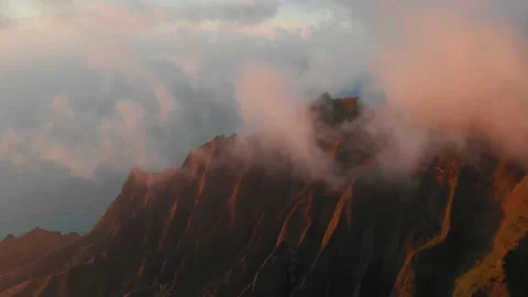 Drone captures sunset light in the clouds and mountain slopes in Waimea Canyon Video stock 138237724