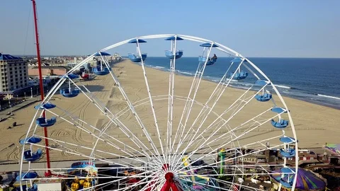 Drone captures top of running ferris wheel on the Ocean City Pier on sunny day Stock Footage 89450007