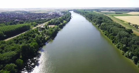 Drone captures a town on one side and fields on other side of Tisza river in Stock Footage 266158247