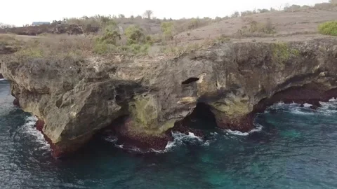 The drone captures the waves of the blue sea and mountains of Indonesia. Stock Footage 155987740