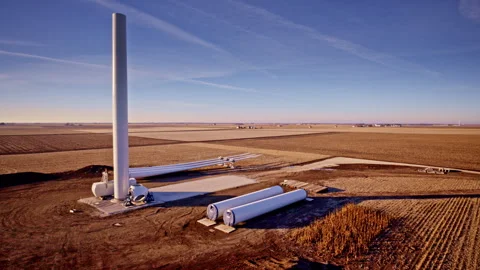 Drone capturing 360-degree view of windmill construction site Stock Footage 329223096