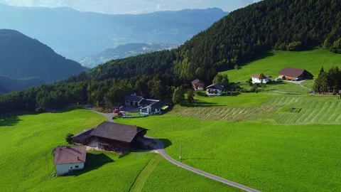 Drone capturing aerial views of rural farms and mountains in Italian Alps Video stock 342343308