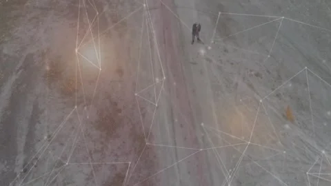 Drone capturing man walking dog along narrow track with technology overlay Stock Footage 329690966