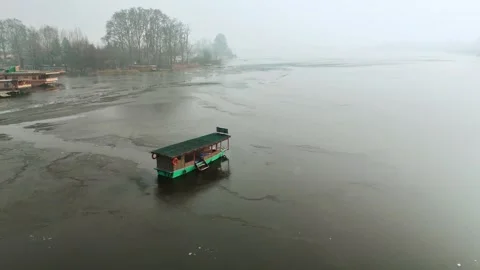 Drone capturing the solitude of boat in Nageen’s frozen captivity. Stock Footage 311022180