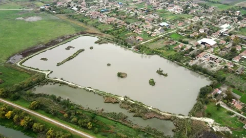 Drone capturing surroundings on a fish pond in a village in Serbia Stock Footage 256418003