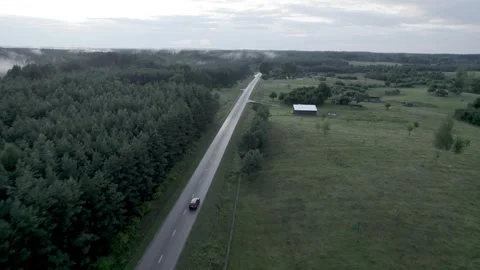 Drone Car Driving On Empty Road Along Sunny Summer Forest Video stock 243627540
