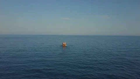 Drone is catching up with a floating ship. On the left there is a boat and a Stock Footage 93297241