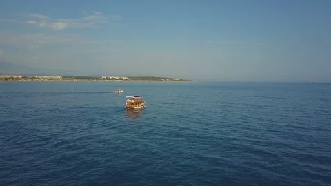 Drone is catching up with a floating ship. On the left there is a boat and a Stock-Footage 93297620