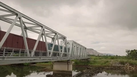 A drone chases a freight train as it passes a Vietnamese village. Video stock 255688564