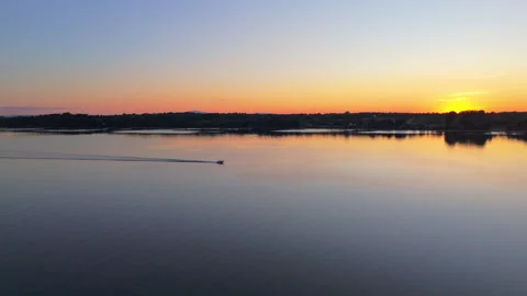 Drone Chasing Speedboat on Lake at Sunset Stock Footage 317359382