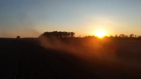 Drone chasing tractor through dense dust cloud Видео 335335772