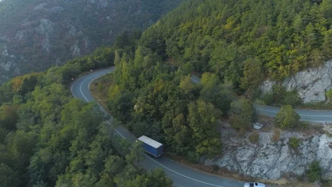 Drone chasing a truck and two cars on mountain passage road with beautiful Stock Footage 116475287