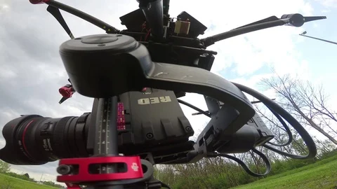 Drone with cinema camera on it taking off- Stock Footage 76000303