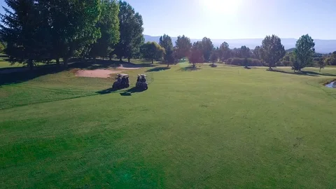 Drone circle around driving golf carts Stock Footage 105605418