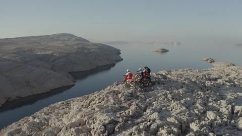 Drone circle of motorcycle riders on top of cliff Stock Footage 274943641