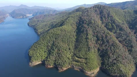 Drone Circle Shot Around Forested Peninsula in Mountain Lake Anhui China Stock Footage 330457043