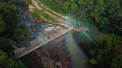 Drone circle shot of the Dam and river in the middle of forests in the morning Stock Footage 157729954