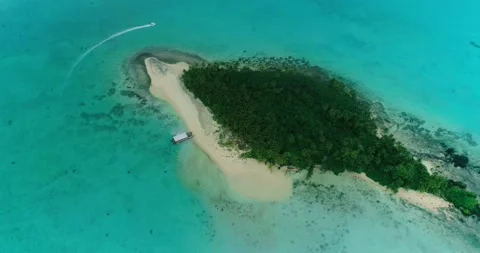 Drone circle top shot, lonely island in turquoise water, boat goes around. Stock Footage 201521320