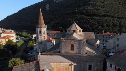 A drone circles a clock tower and medieval buildings in the ol quarter of Video stock 114514098