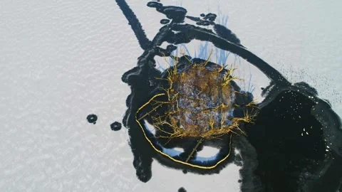 Drone circles counter clockwise above small island in lake at wintertime Stock Footage 278363167