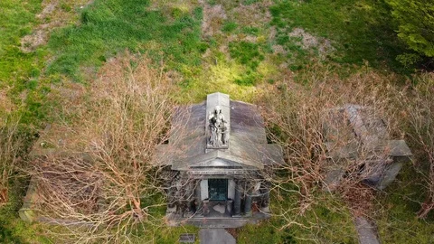 Drone circles gothic statue atop mausoleum Greenwood Cemetery Stock Footage 129274172
