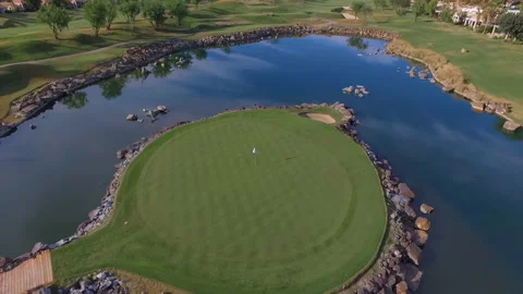 Drone circles hole on golf course on island overhead Stock Footage 167142476