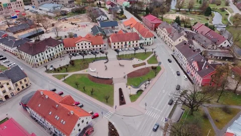 Drone Circles Kalpaka Square and Historic Town Center of Saldus in Spring Stock Footage 322221886