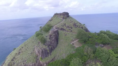 Drone circles mountain top and landmark - St Lucia Stock Footage 61859098