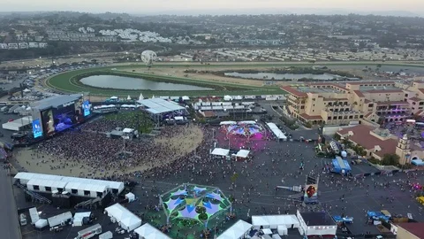Drone circles near outdoor music concert with huge crowd in California Stock Footage