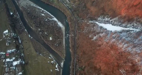 A drone circles over a winter river on a snow bank Stock Footage 123613497